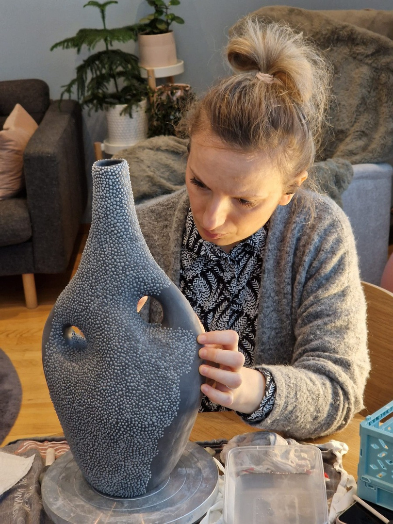 Jelena shaping clay in the Totus studio, Espoo