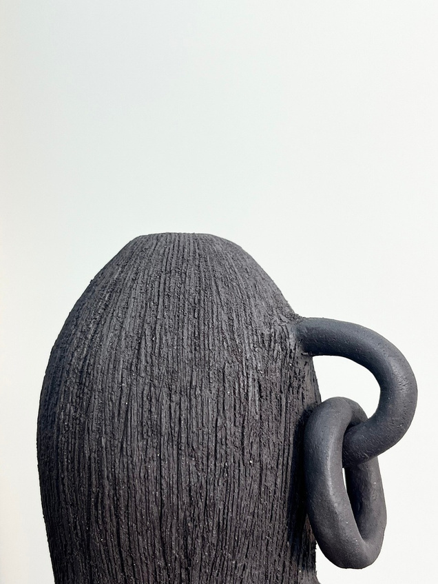 Broken bonds sculpture, two dark stoneware vertical forms connected by hand-rolled clay chains — view 3