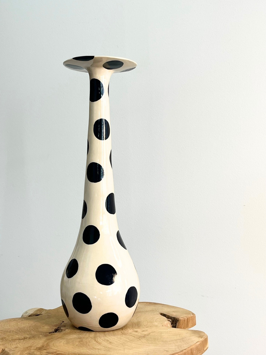 La Belle vase, tall white stoneware with a wide disc rim and bold black glaze polka dots