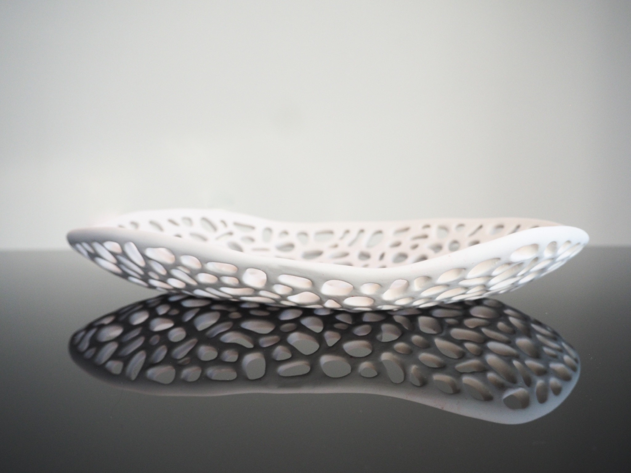 Lumi sculpture, pale matte stoneware form with soft rounded shape and botanical pressed textures