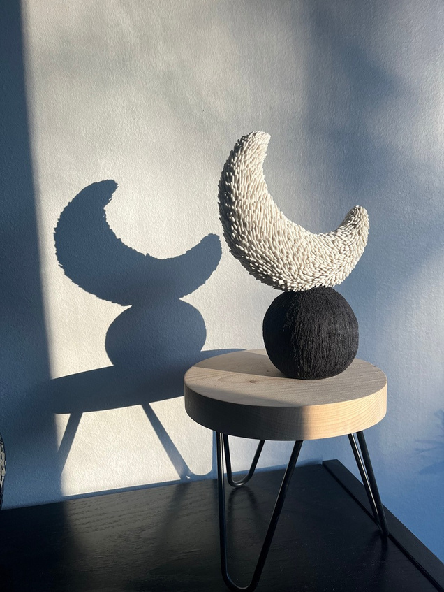 Luna sculpture, crescent of white porcelain with pressed texture resting on a dark stoneware sphere — view 5