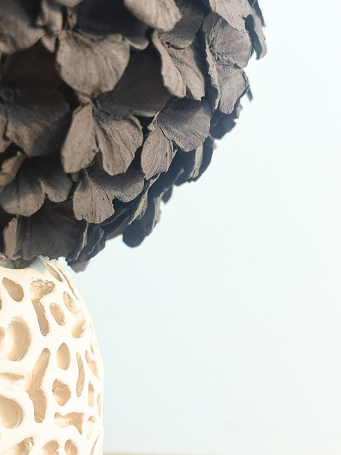 Tear on the Danube sculptural form, compact sphere with alternating dark stoneware petals and pale carved lace-like base — view 2